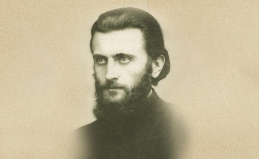 Portret fotografic sepia al lui Arsenie Boca în tinerețe